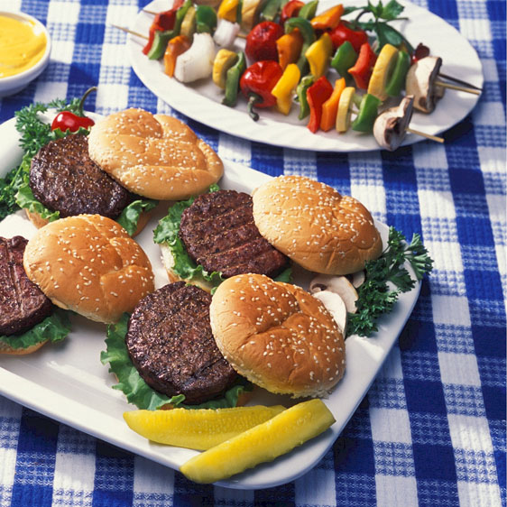 hamburgers shishkabobs on picnic table