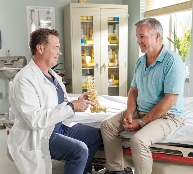 Dr. Castro of Beaufort Memorial holding a spine model.