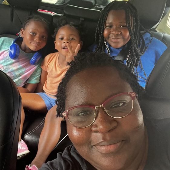 Hyacitha Gordon photographed with her three children in a car