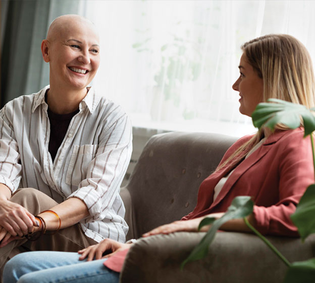 Two women sitting on a couch talking