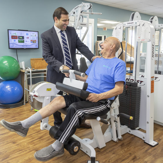 surgeon checking on knee replacement patient doing rehab 