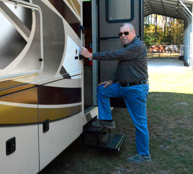 Larry Cooke, knee replacement patient at Beaufort Memorial, climbs into his RV.