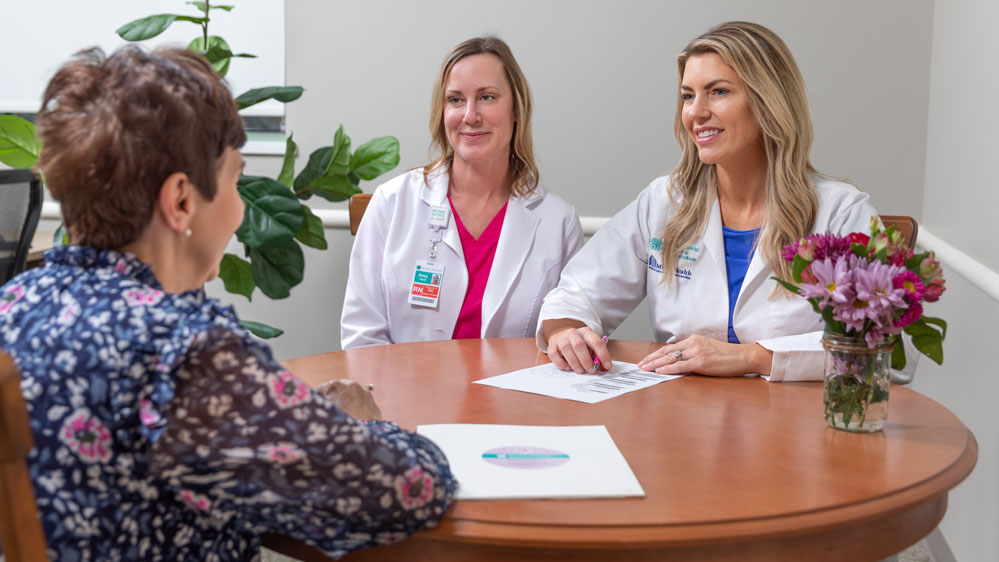 Breast cancer care team meets with patient