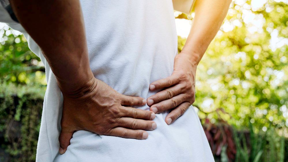 Man holding his Back in Pain