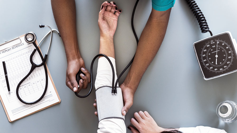 provider measuring a patient's blood pressure