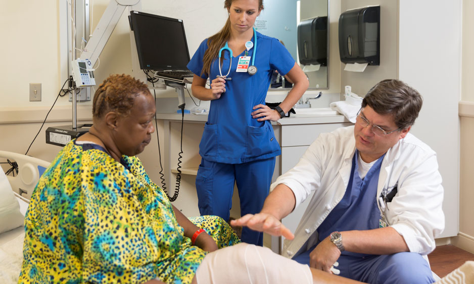 physician speaking with knee replacement patient