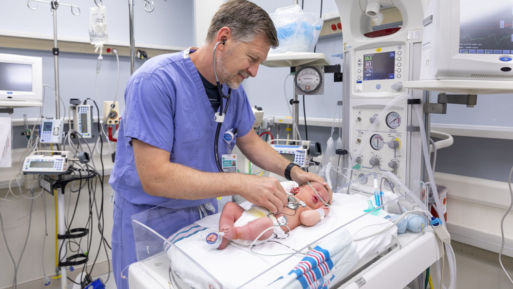 doctor checking a baby in the Beaufort Memorial level II nursery