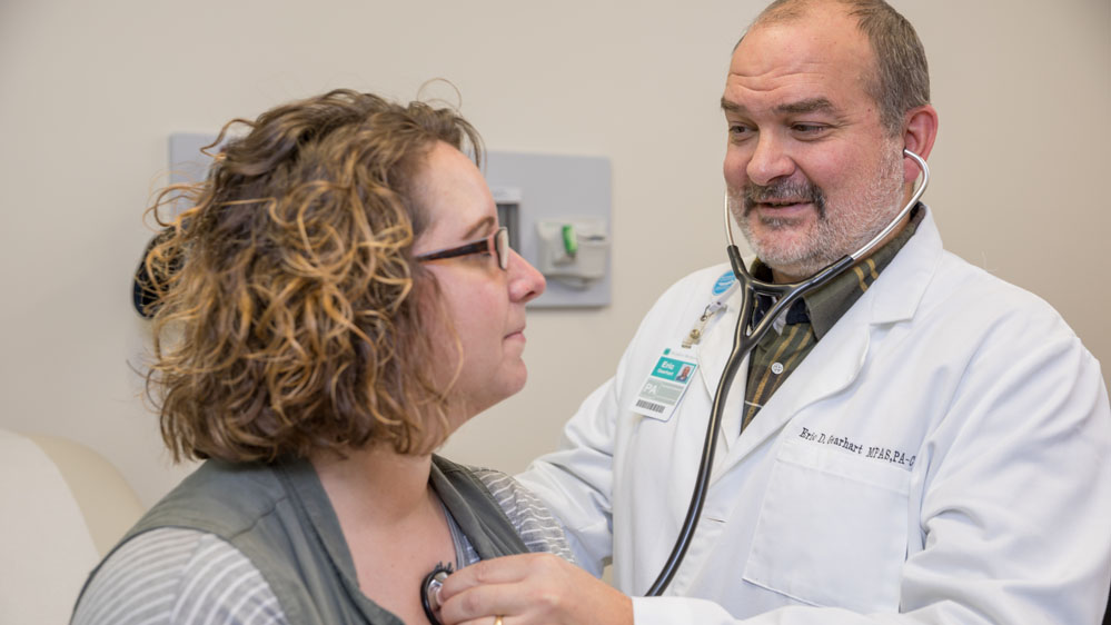 physician listening to a patient's heart