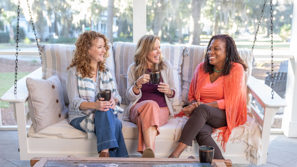 three women sitting on the back poarch